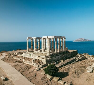 Aerial view of the ancient Temple of Poseidon overlooking the Aegean Sea in Greece.