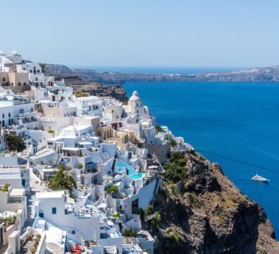 Beautiful Santorini houses overlooking the Aegean Sea on a sunny day.
