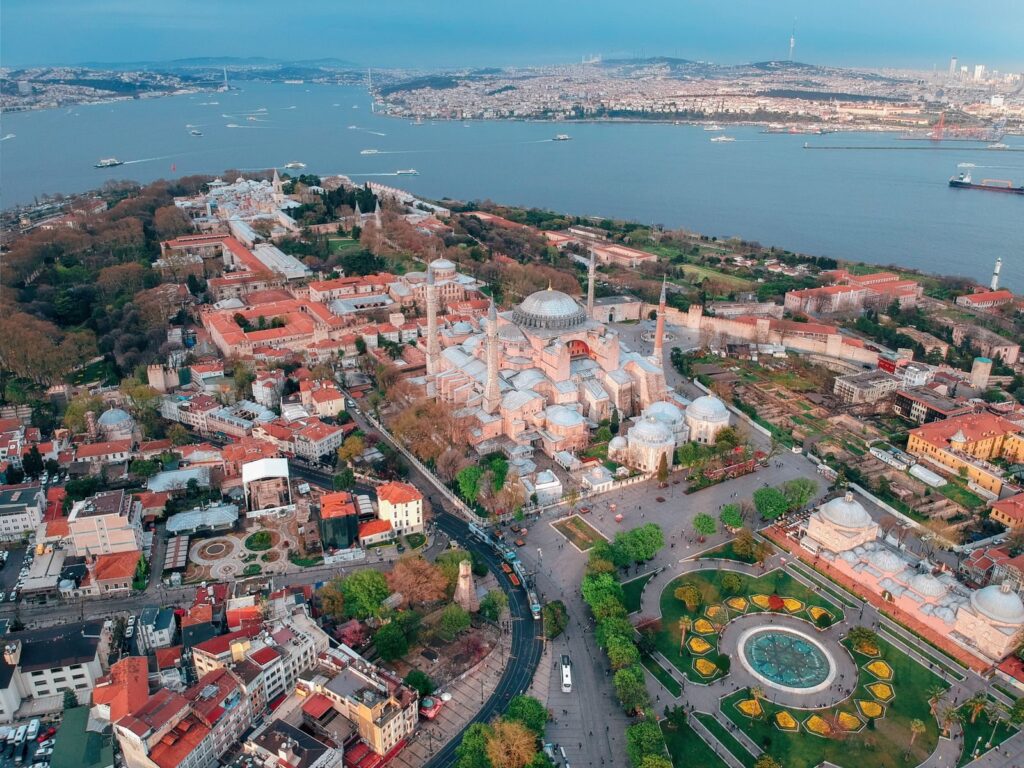 Breathtaking aerial view of Hagia Sophia and the Bosphorus in Istanbul, showcasing the city's iconic architecture and vibrant landscape.