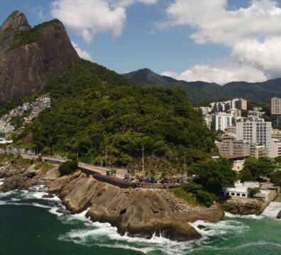 Stunning aerial view of Vidigal Beach with lush greenery and cityscape in Rio de Janeiro, Brazil.