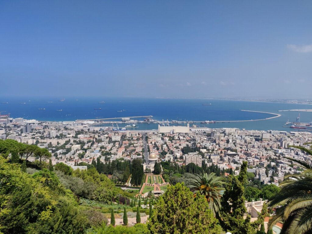Stunning aerial view of Haifa, Israel, featuring the Baha'i Gardens and the Mediterranean Sea.