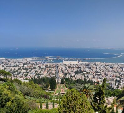 Stunning aerial view of Haifa, Israel, featuring the Baha'i Gardens and the Mediterranean Sea.