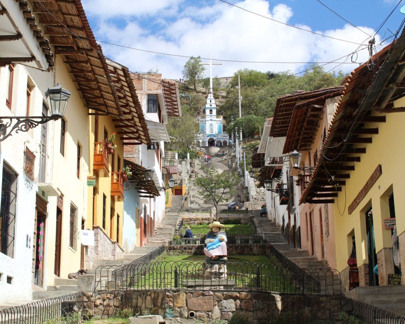 Picturesque view of Cajamarca's vibrant streets leading to Mirador Santa Apolonia in Peru, with colorful colonial architecture.