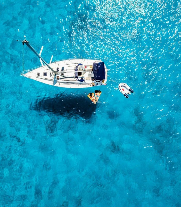 white yacht in middle of blue sea